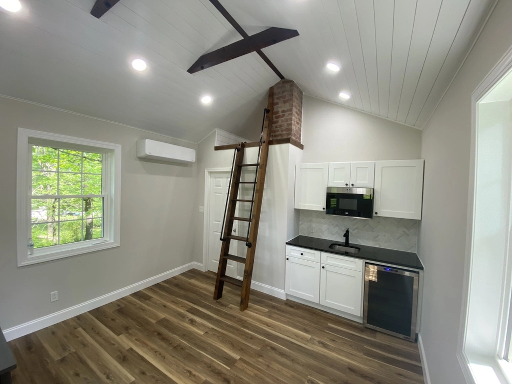 Kitchen Remodeling: bright kitchenette with hardwood flooring, vaulted ceiling, loft ladder and recessed lighting