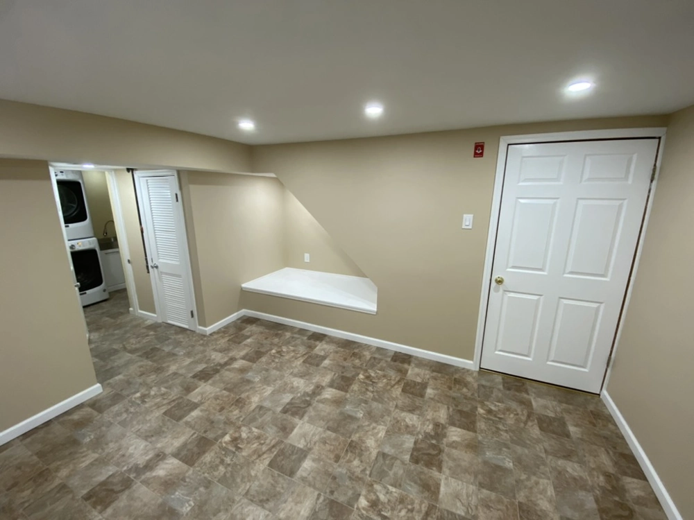 Basement Finishing: room with vinyl flooring, recessed lights, beige painted walls, laundry closet and interior door