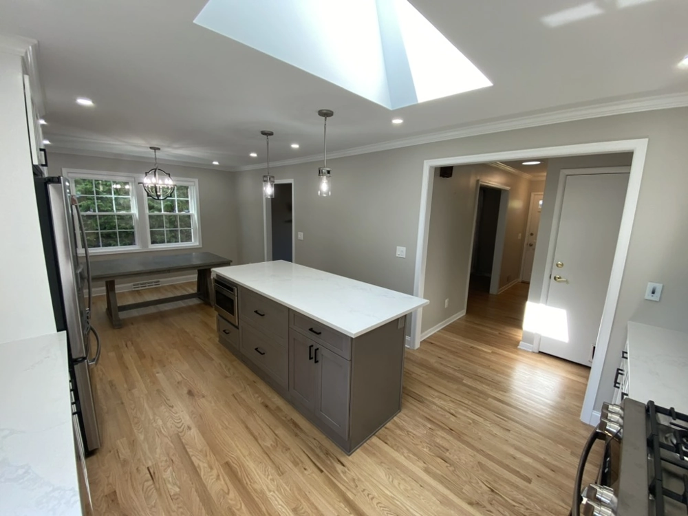 Modern kitchen interior with central island, hardwood floors and new paint Kitchen Remodeling