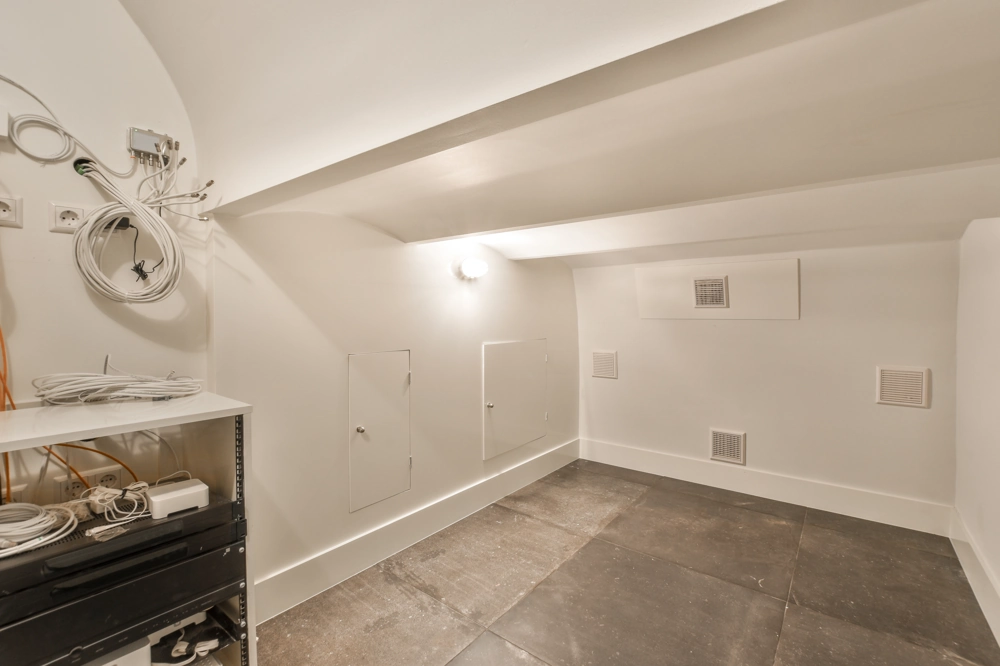 Attic space with exposed electrical cabling and new light fixture after Electrical Work