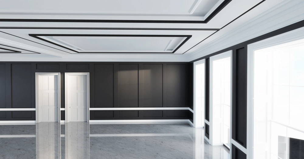 Spacious room showcasing home remodeling with black paneled walls, white trim, coffered ceiling and polished floor