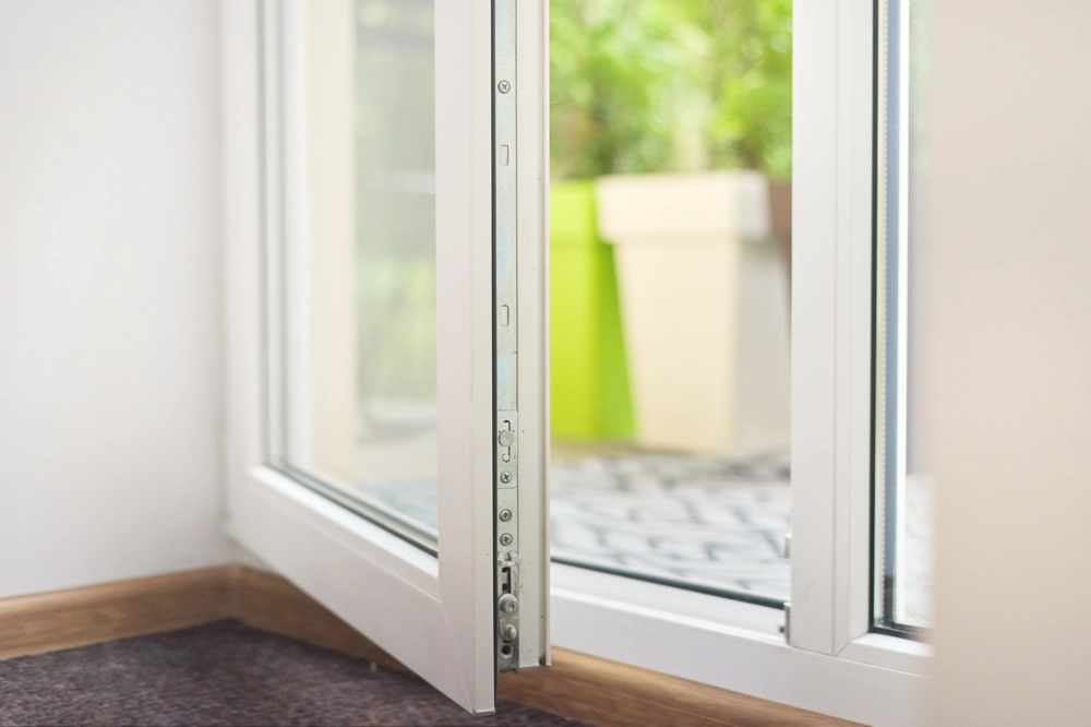 Open white tilt and turn window to patio planter, showcasing Tilt and Turn Windows